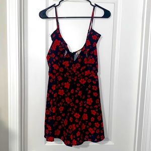 A Peach Size L Black Sleeveless Romper with Red Floral Design
